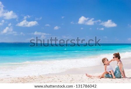 Mother and daughter enjoying beach vacation