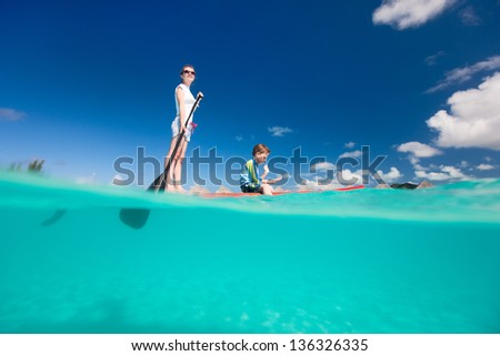 Mother and son paddling on stand up paddle board