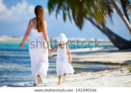 Back view of mother and daughter on a deserted island