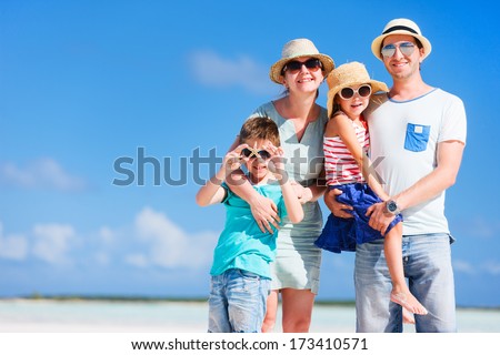 Happy Beautiful Family Posing At Beach During Summer Vacation