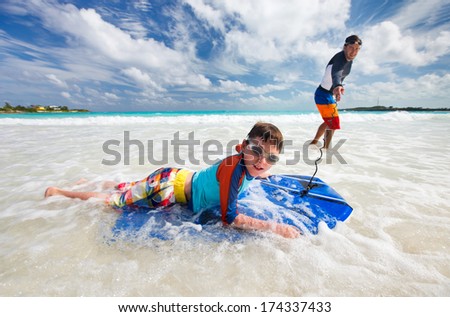 Father and son surfing on boogie boards