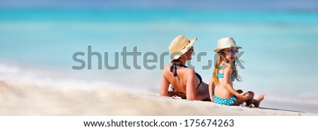 Mother and daughter enjoying time at tropical beach