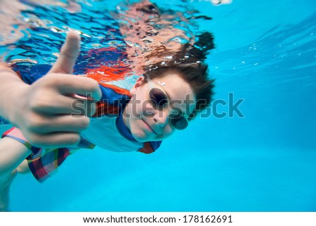 Cute little boy underwater in swimming pool