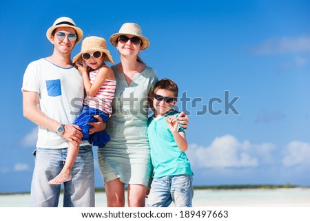 Happy beautiful family on a beach during summer vacation