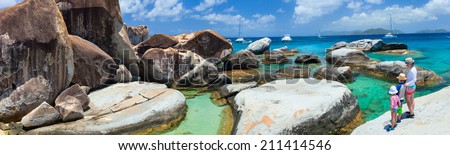 Family of mother and kids enjoying view of beautiful scenery of The Baths beach area major tourist attraction at Virgin Gorda, British Virgin Islands, Caribbean