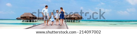 Happy beautiful family during summer vacation at luxury resort wide panorama with copy space, perfect for banners