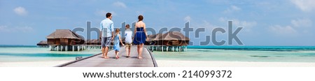 Happy beautiful family during summer vacation at luxury resort wide panorama with copy space, perfect for banners
