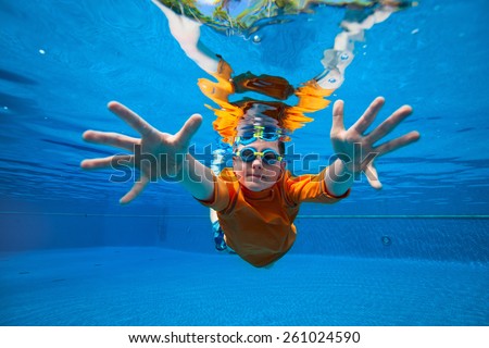 Cute boy underwater in swimming pool