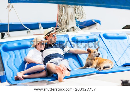 Father, son and their pet dog sailing on a luxury yacht or catamaran boat