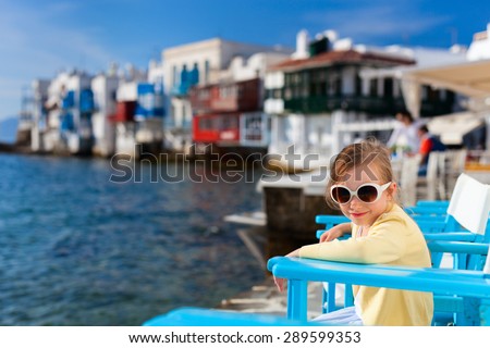 Cute little girl at Little Venice popular tourist area on Mykonos island, Greece