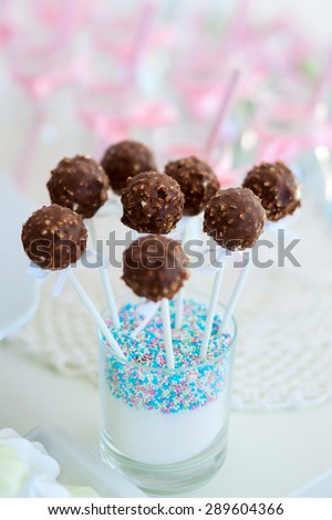 Chocolate cake pops on a dessert table at party or wedding celebration