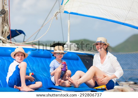 Mother and her kids relaxing having great time sailing at luxury yacht or catamaran boat