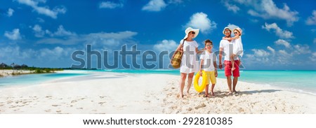 Panorama of happy beautiful family with kids walking together on tropical beach during summer vacation