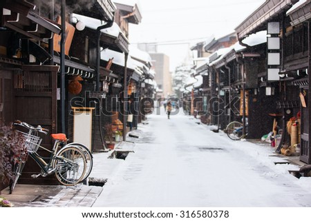 Old district wooden houses at historical Takayama town in Japan on winter day