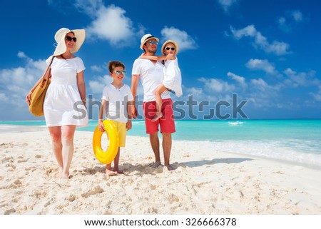 Happy beautiful family with kids on a tropical beach vacation