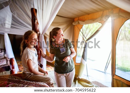 Family mother and her child in safari tent enjoying vacation in Africa