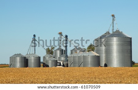 Agricultural grain bins in a farm field
