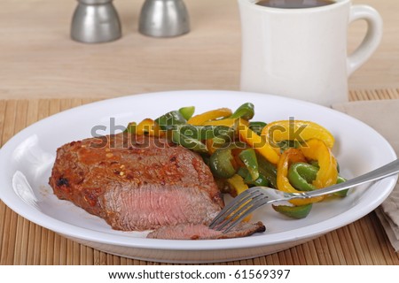 Pepper sirloin steak with green and yellow bell peppers