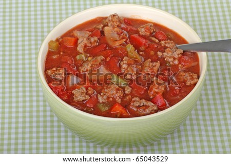 Bowl of chili with beans in a green bowl