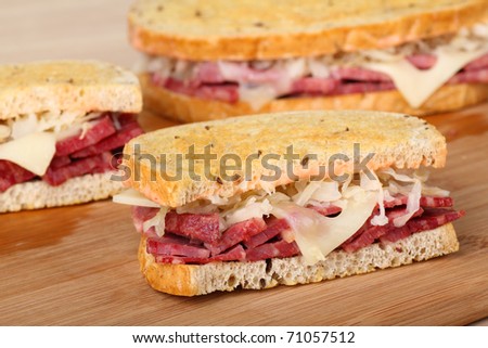 Sliced reuben sandwich with corned beef, sauerkraut and swiss cheese