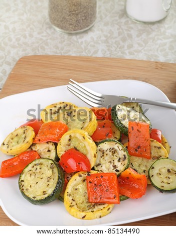 Seasoned baked squash and red peppers on a plate
