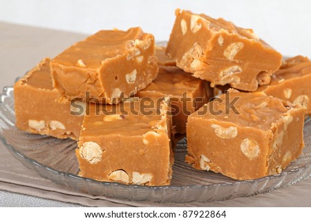 Stack of peanut butter fudge on a glass plate