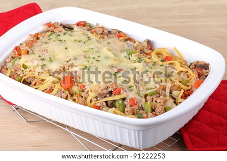 Noodle casserole with melted cheese in a baking dish