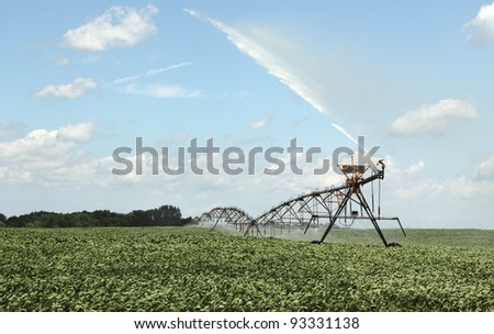 Irrigating farm field of a crop of soybeans