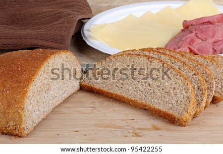 Rye bread sliced on a cutting board for making sandwiches