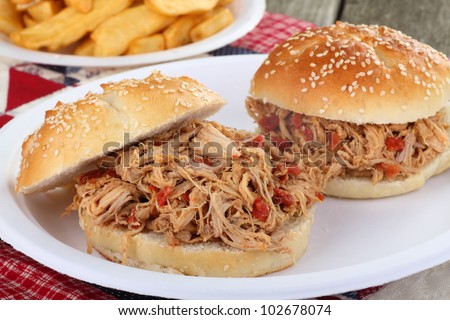 Two pulled pork sandwiches on sesame seed buns