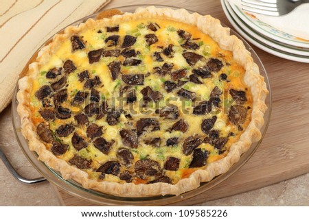 Baked mushroom quiche in a pie dish