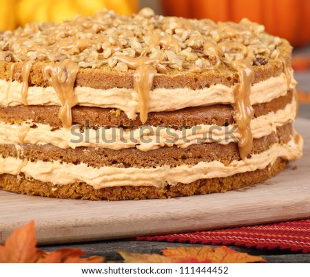 Whole layer pumpkin cake topped with nuts and caramel