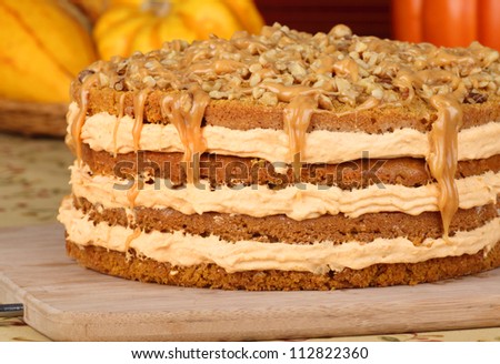 Pumpkin layer cake topped with caramel and nuts