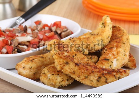 Fried breaded chicken tenderloins on a platter