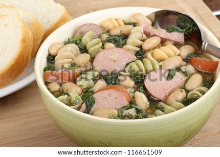 Bowl of kielbasa bean and spinach soup