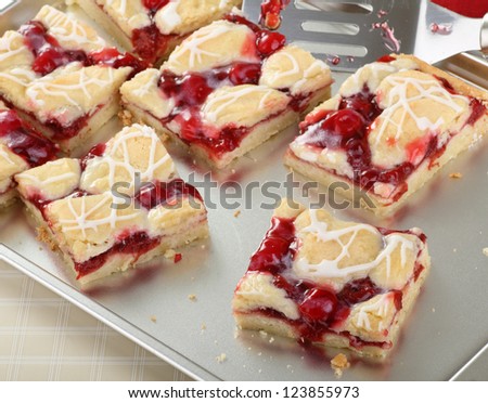 Homemade cherry fruit bars on a baking sheet