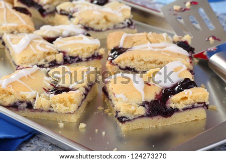 Sliced blueberry fruit bars on a baking sheet