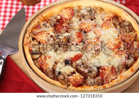 Deep dish pan pizza with sausage, pepperoni and mushrooms