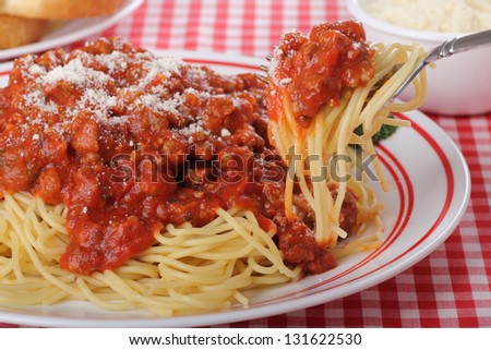 Plate of spaghetti with meat sauce with spaghetti on a fork