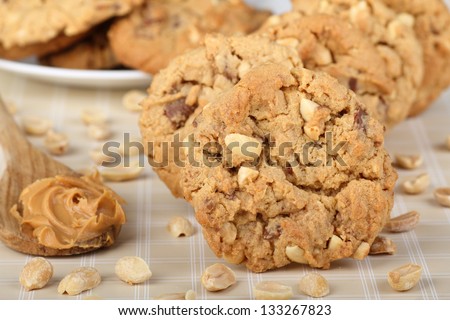 Peanut butter cookies with nuts and a spoon of peanut butter