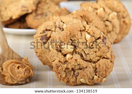 Closeup of peanut butter cookies with spoon of peanut butter alongside