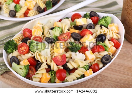 Pasta Salad With Tomato, Broccoli, Black Olives, Cauliflower And Cheese In A Bowl
