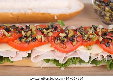 Turkey sub with cheese, lettuce; tomato; and olives