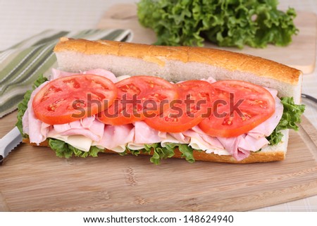French bread with deli ham, cheese, lettuce and tomato