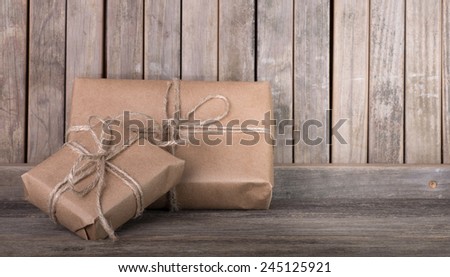Two brown packages on a wood background