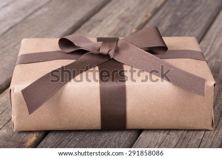 Wrapped gift package on old wood surface