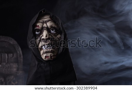 Halloween zombie prop on a dark smoky background
