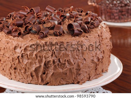 Chocolate layer cake with chocolate curls on a platter