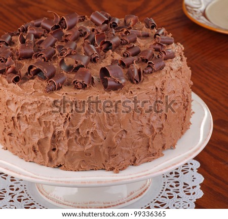Whole chocolate cake on a cake platter