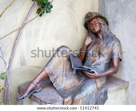 bronze statue of a reading woman.